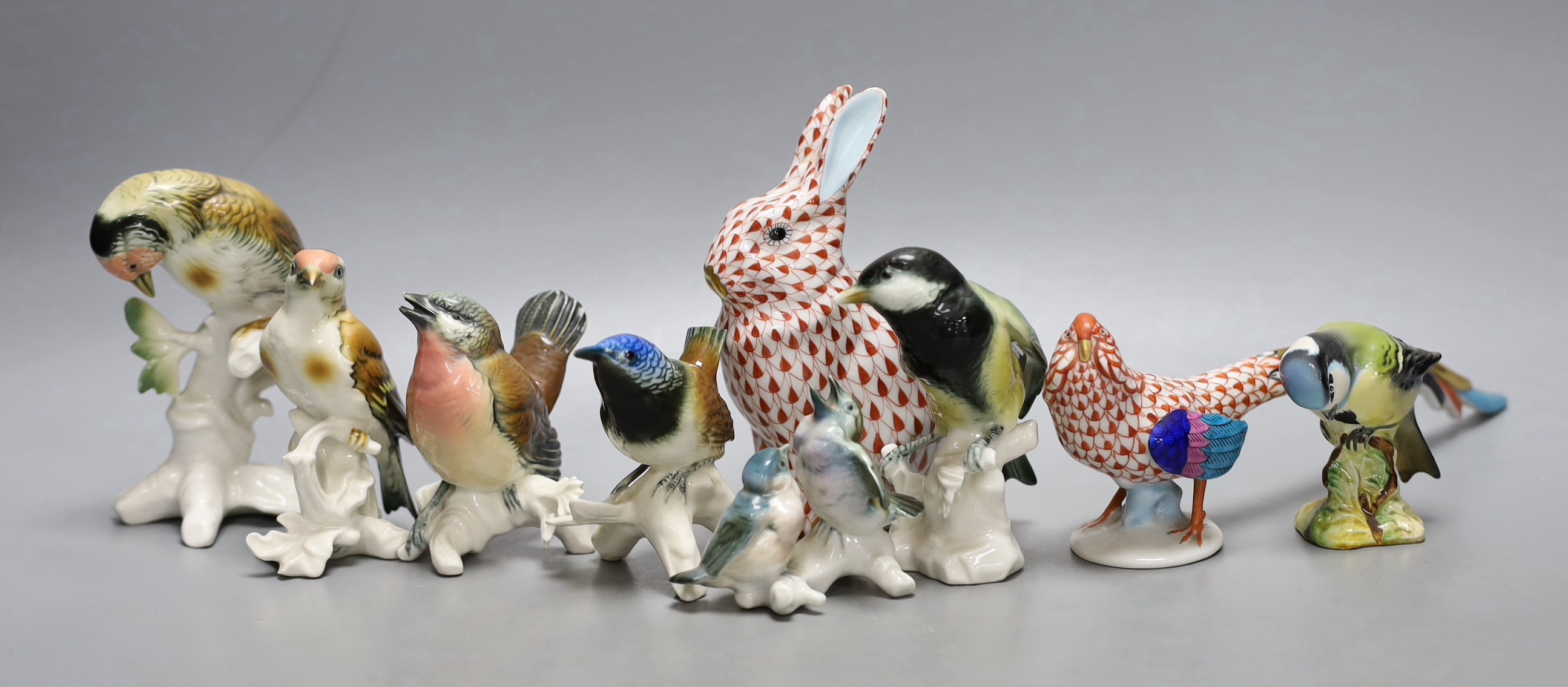 Six Karl Ens porcelain bird models, a Herend red net pattern peacock and a similar rabbit
